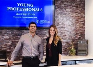 Two young professionals posing at their event.